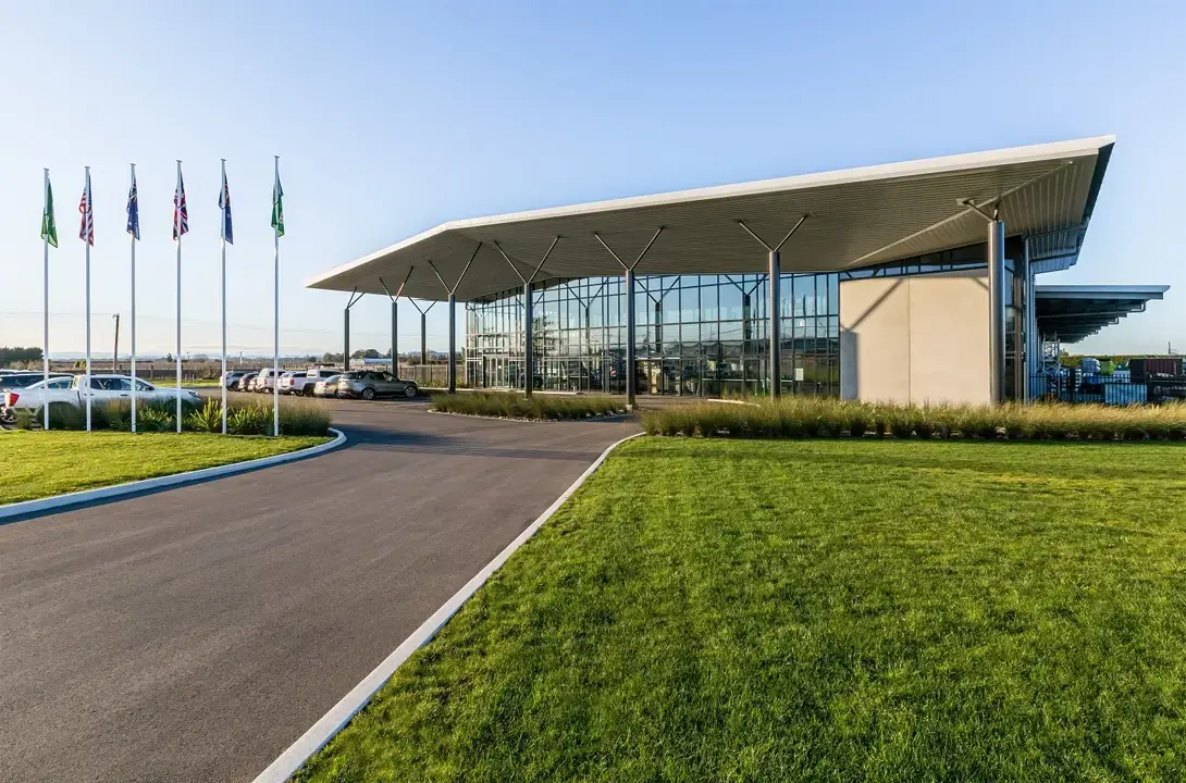 Concrete building with big windows with a carpark